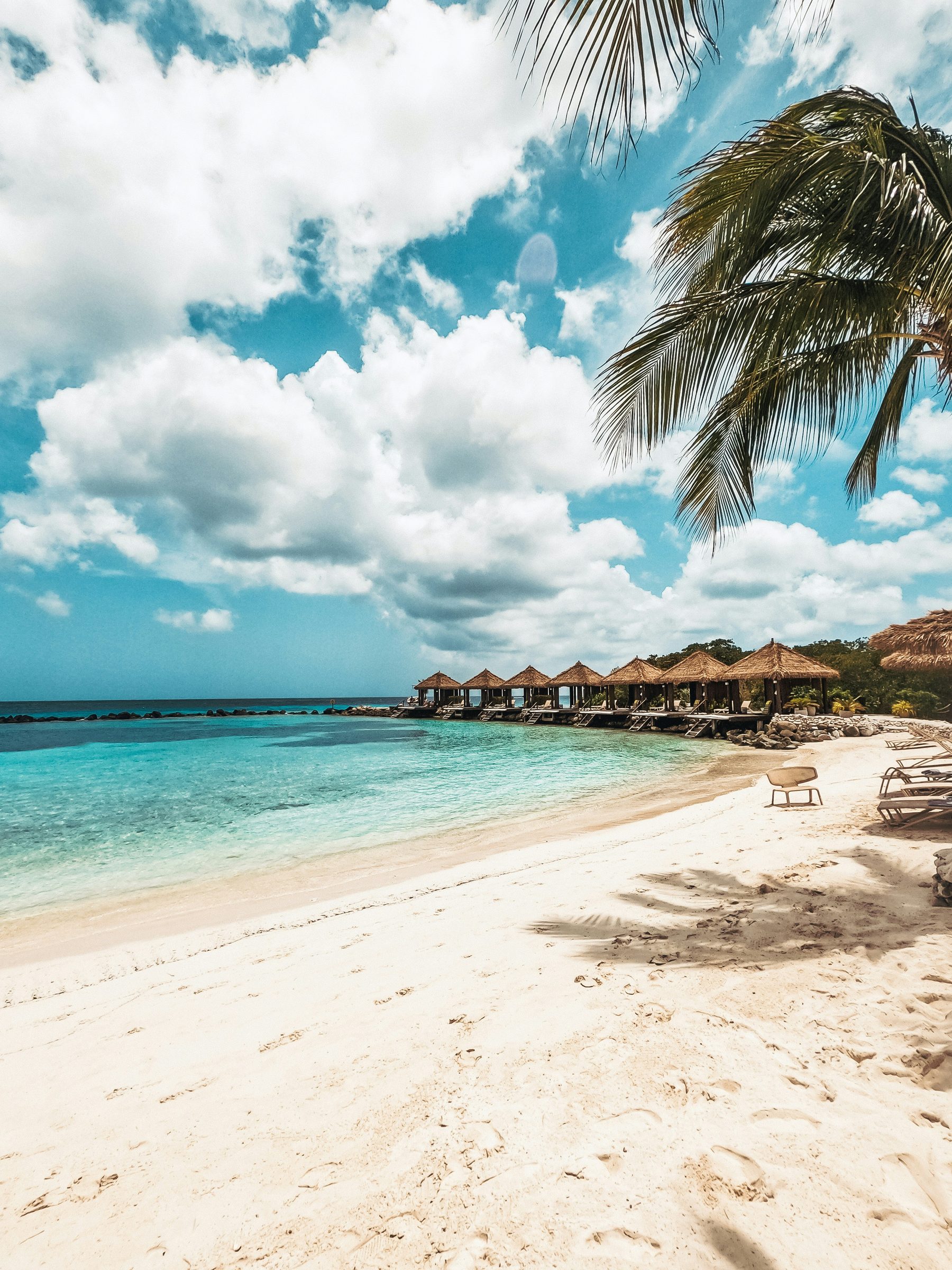 A calm beach with thatched cabanas, Barbados, Caribbean