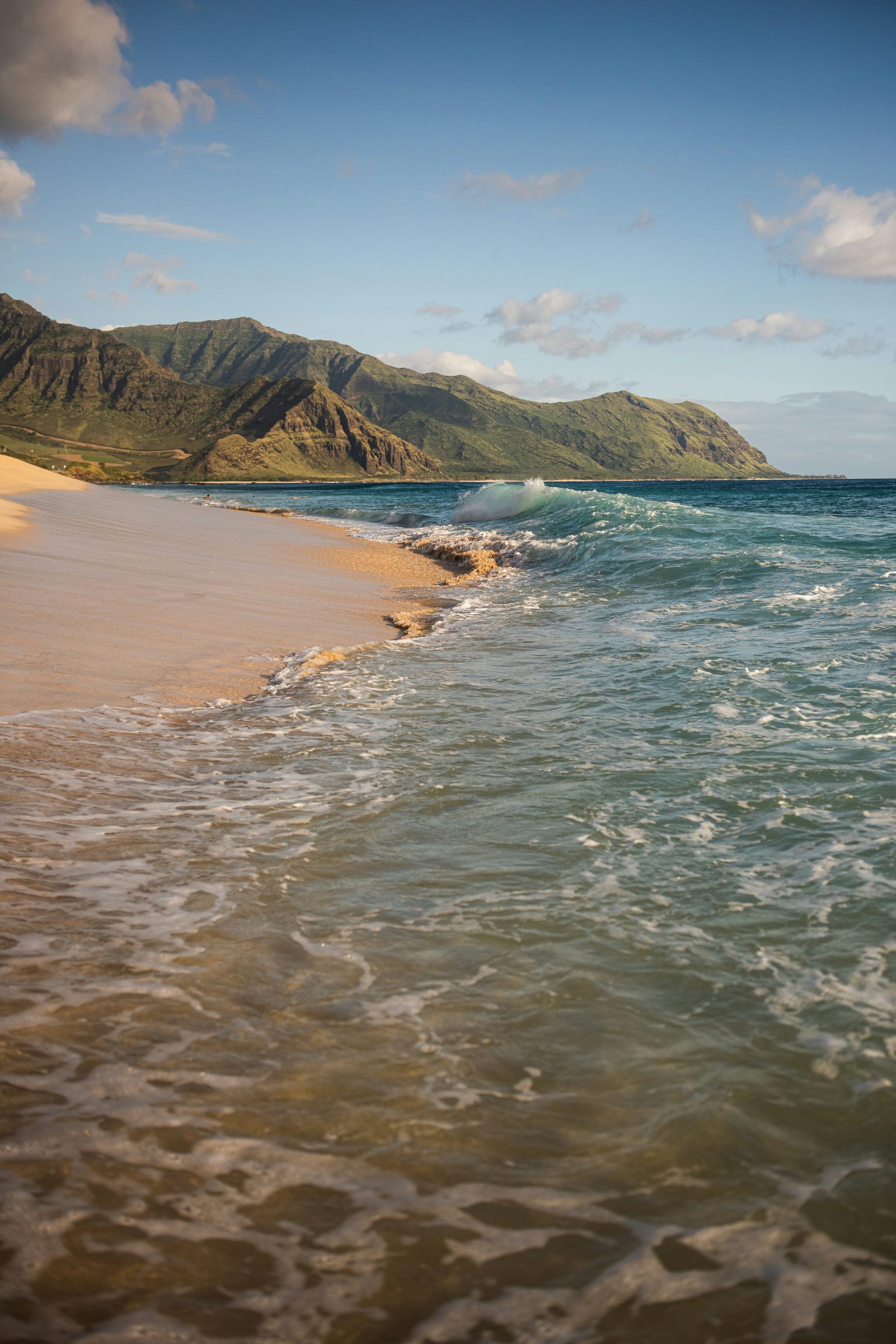 A quiet golden beach below green hills, Mustique, Caribbean