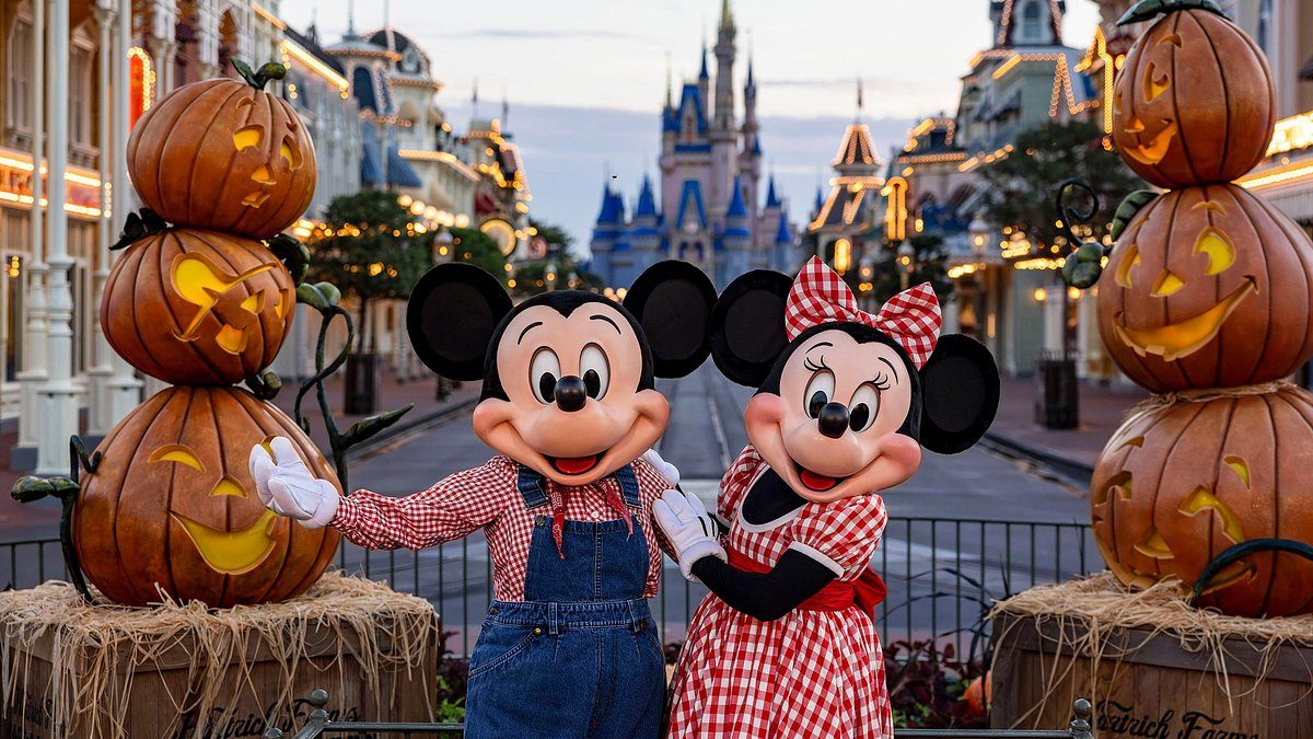 Mickey and Minnie Mouse with autumn pumpkins on Main Street before the castle at Walt Disney World, Orlando, Florida