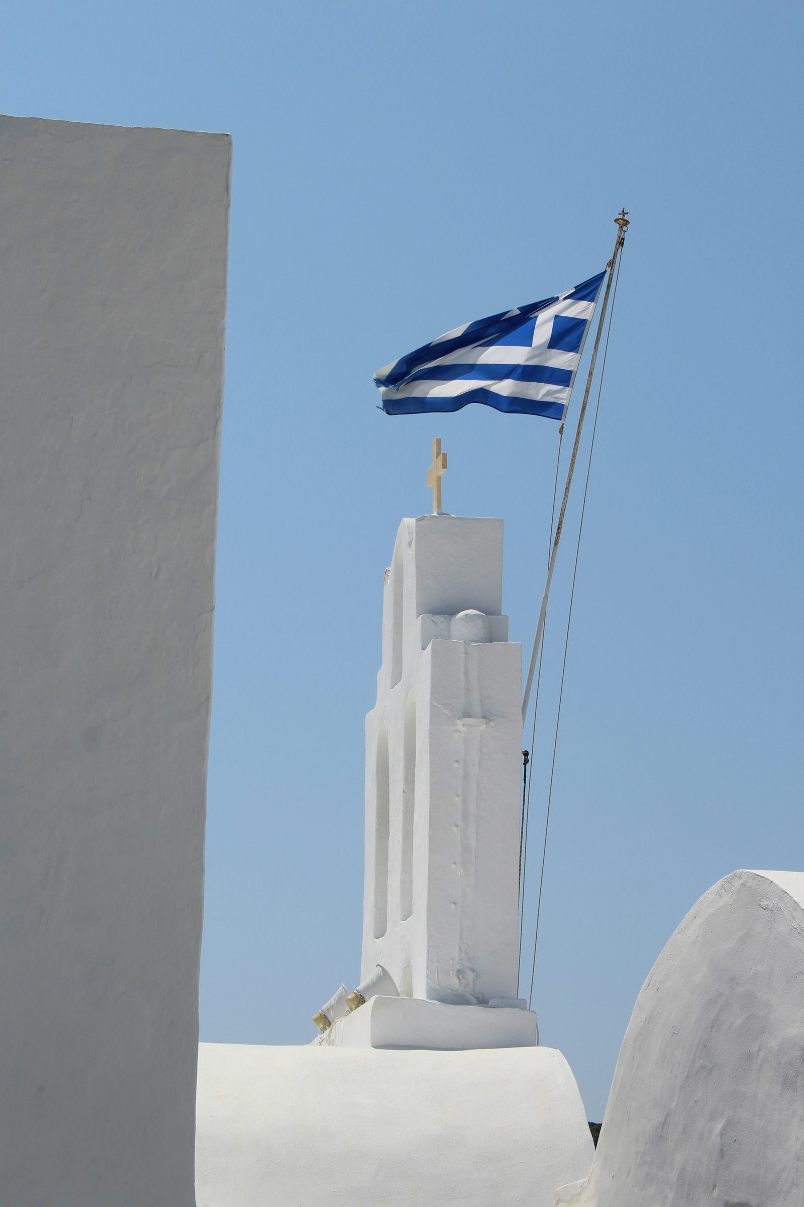 A white chapel and Greek flag, Mykonos, Greece