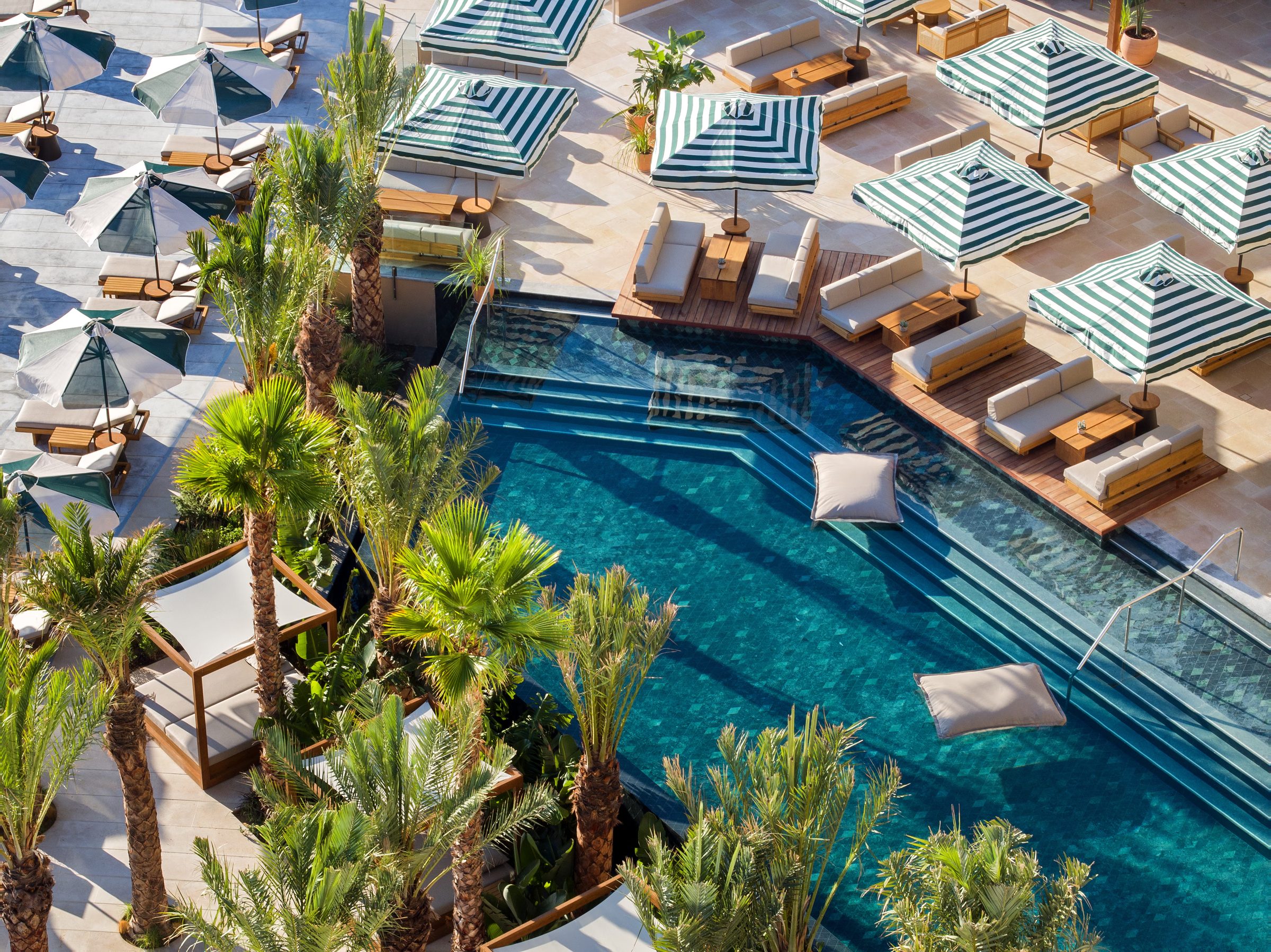 Pool cabanas and loungers above the sea, Daios Cove, Crete