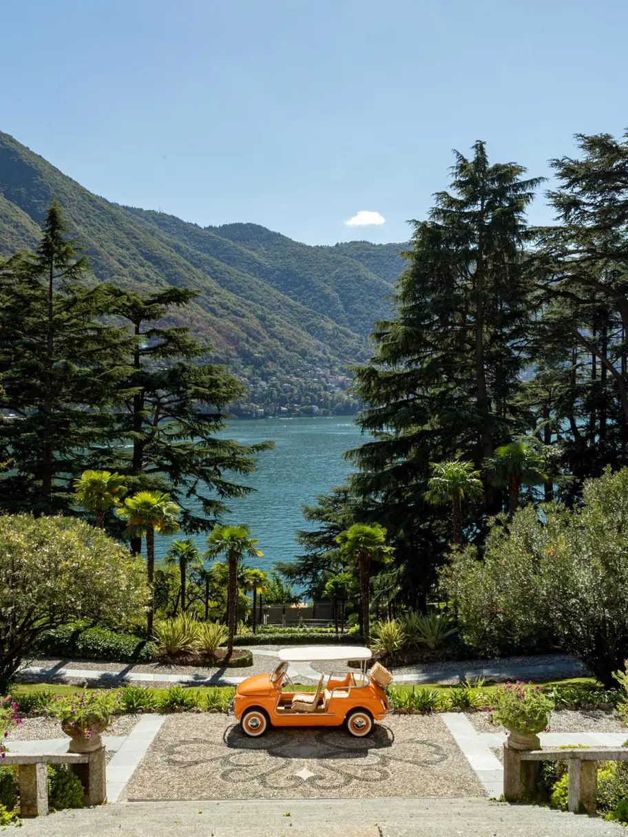 Parasols and gardens beside Lake Como in the morning light