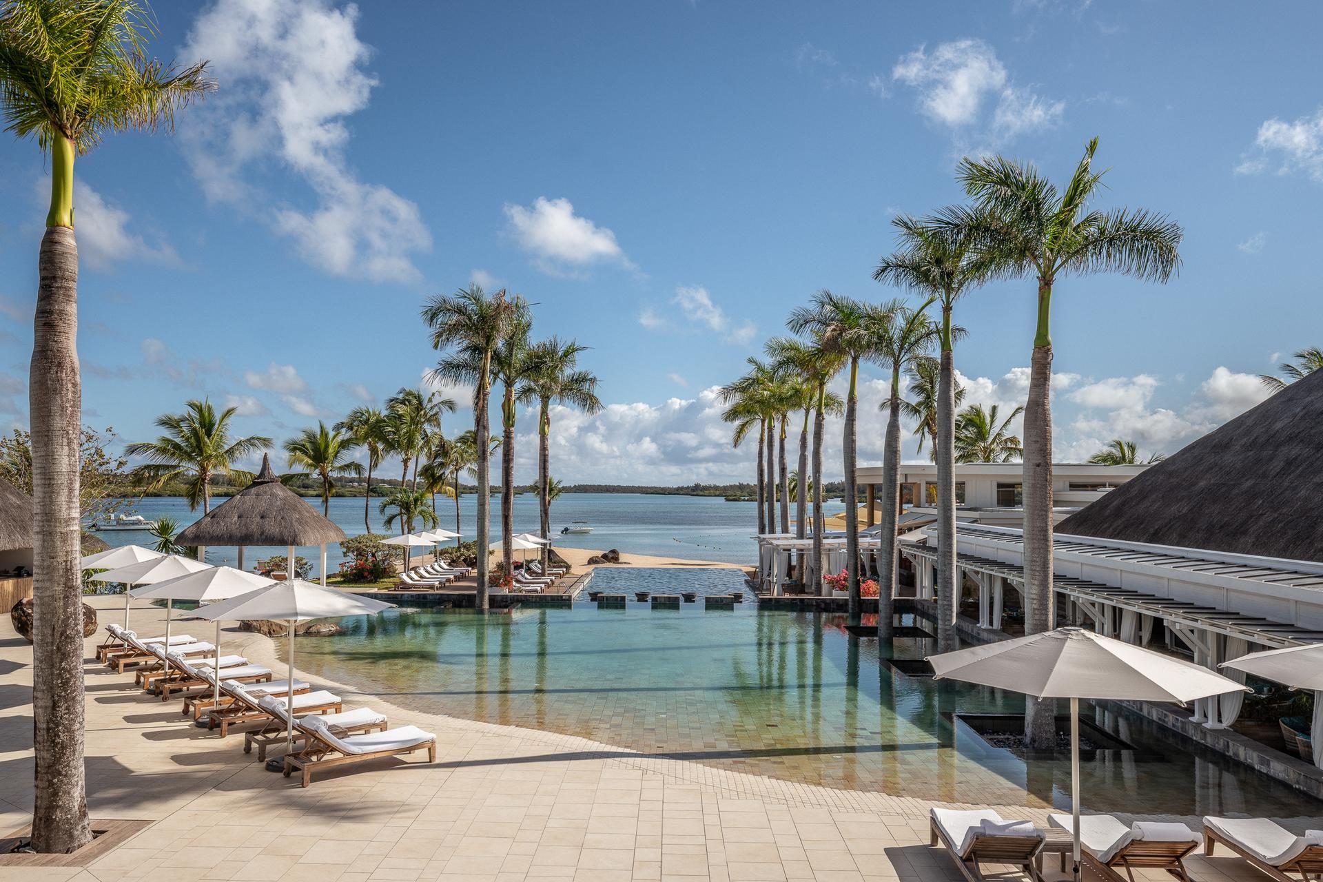 Main pool and loungers overlooking the lagoon, Four Seasons Resort Mauritius at Anahita