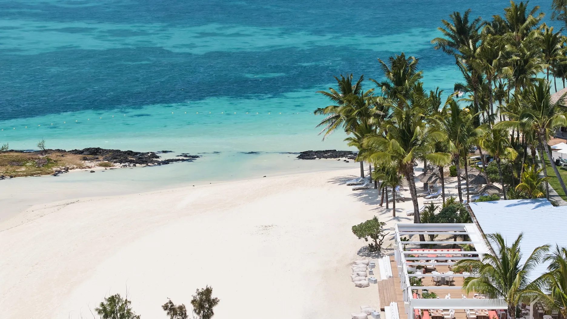 Aerial of the white-sand beach and turquoise lagoon, LUX* Belle Mare, Mauritius