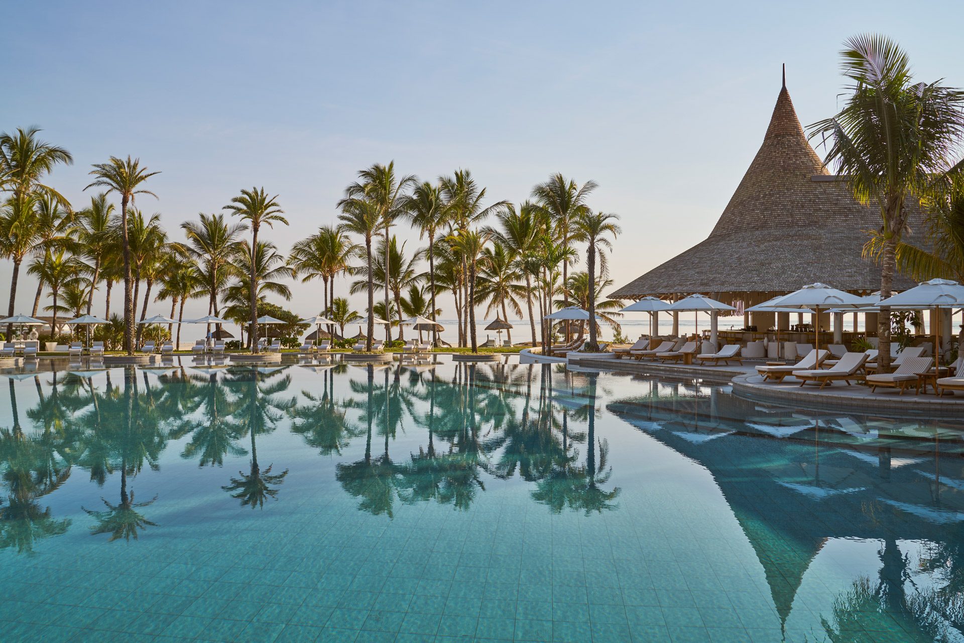 Pool and pavilion reflected at dusk, LUX* Belle Mare, Mauritius