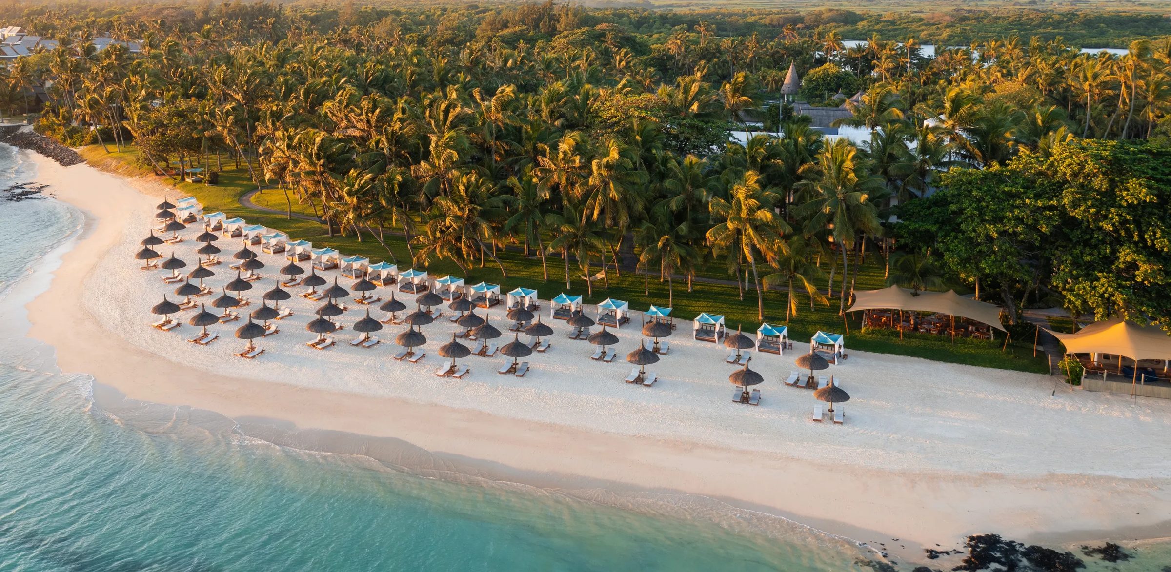 Parasols along the resort beach at golden hour, One&Only Le Saint Geran, Mauritius