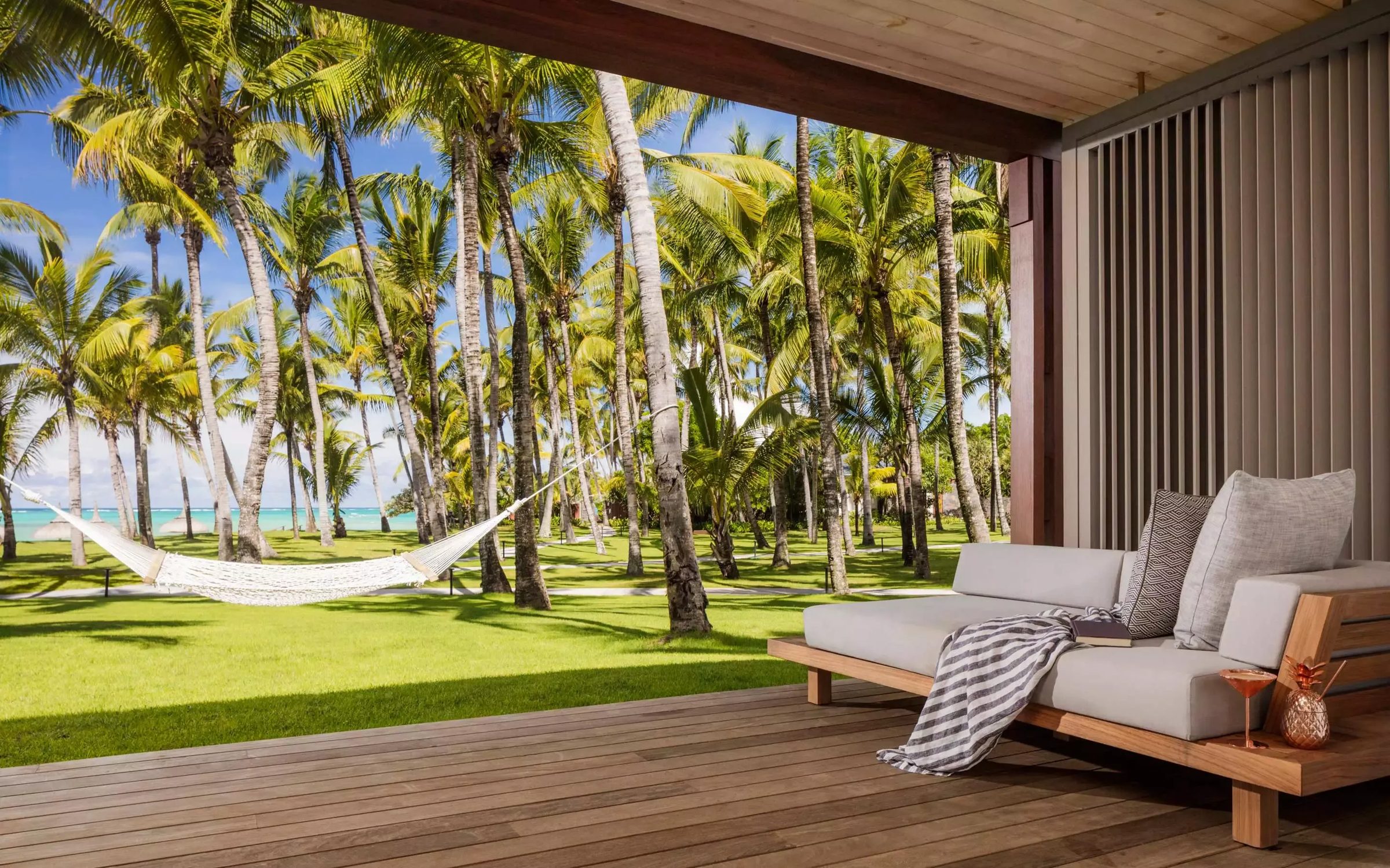 A hammock between palms above the sea, One&Only Le Saint Geran