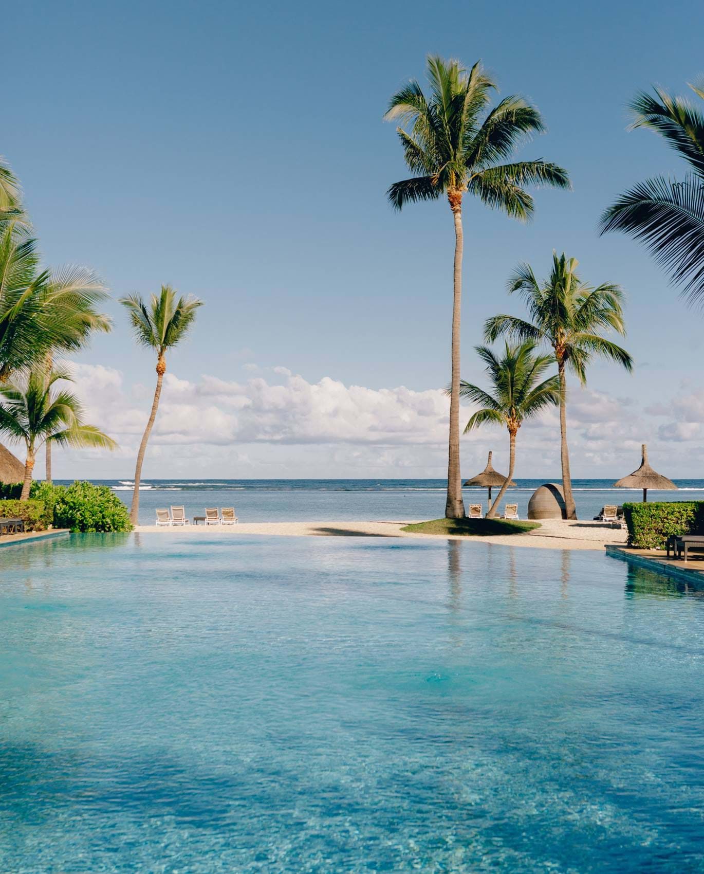 Infinity pool and palms looking out to the sea, Sugar Beach Mauritius