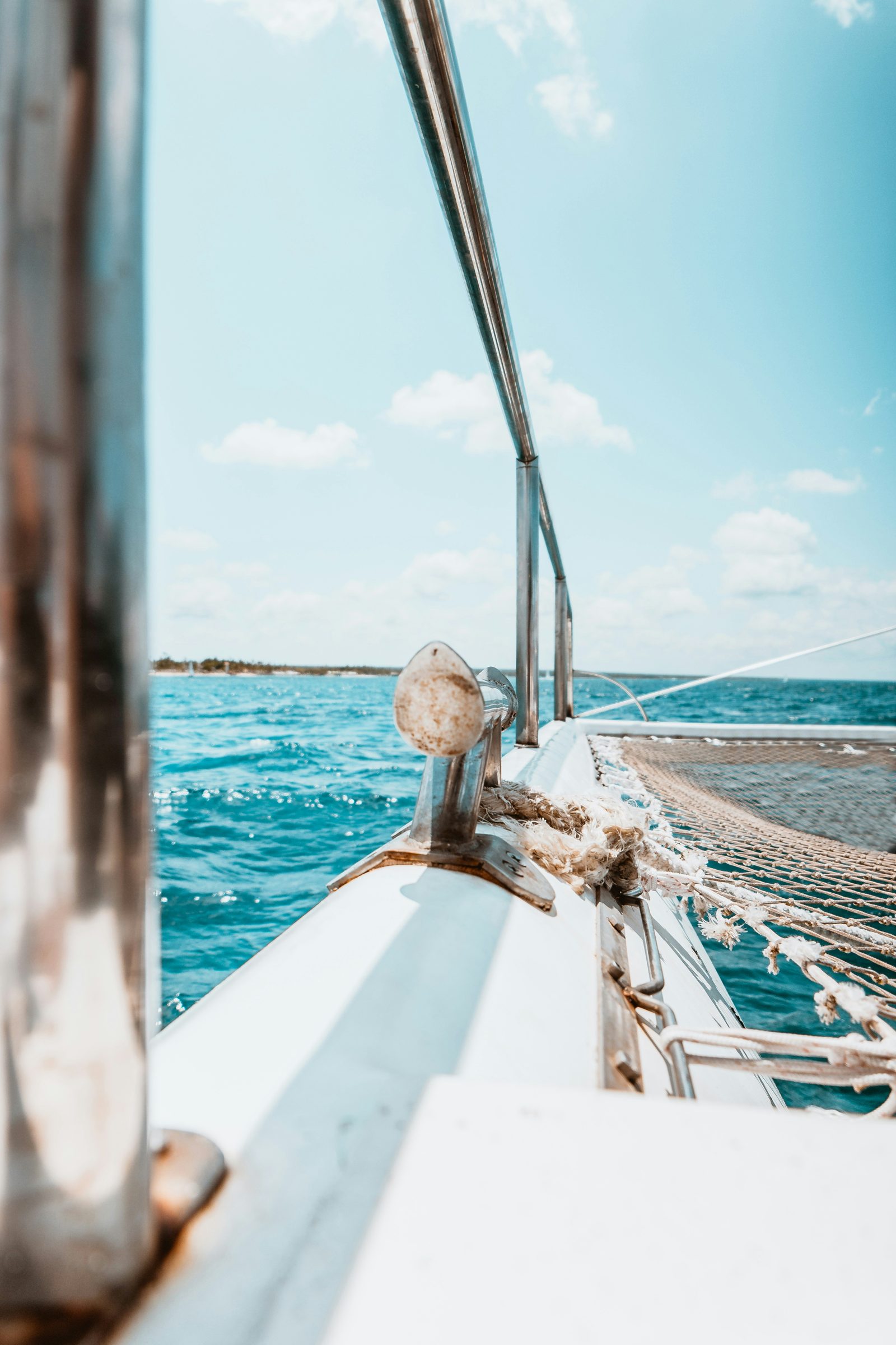 The bow of a catamaran cutting across the turquoise water, Mauritius