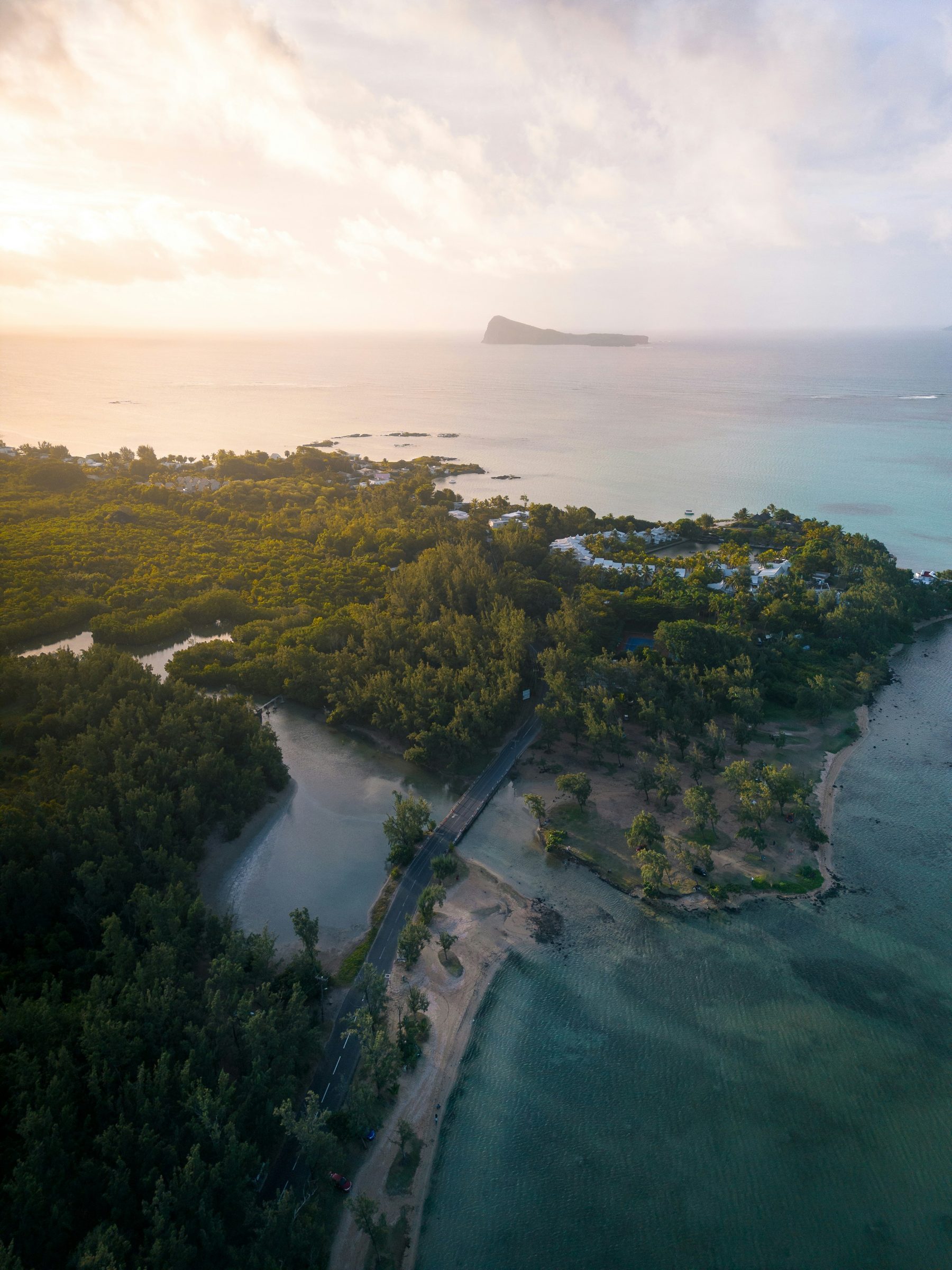 A green northern coast at golden hour with an islet offshore, Mauritius