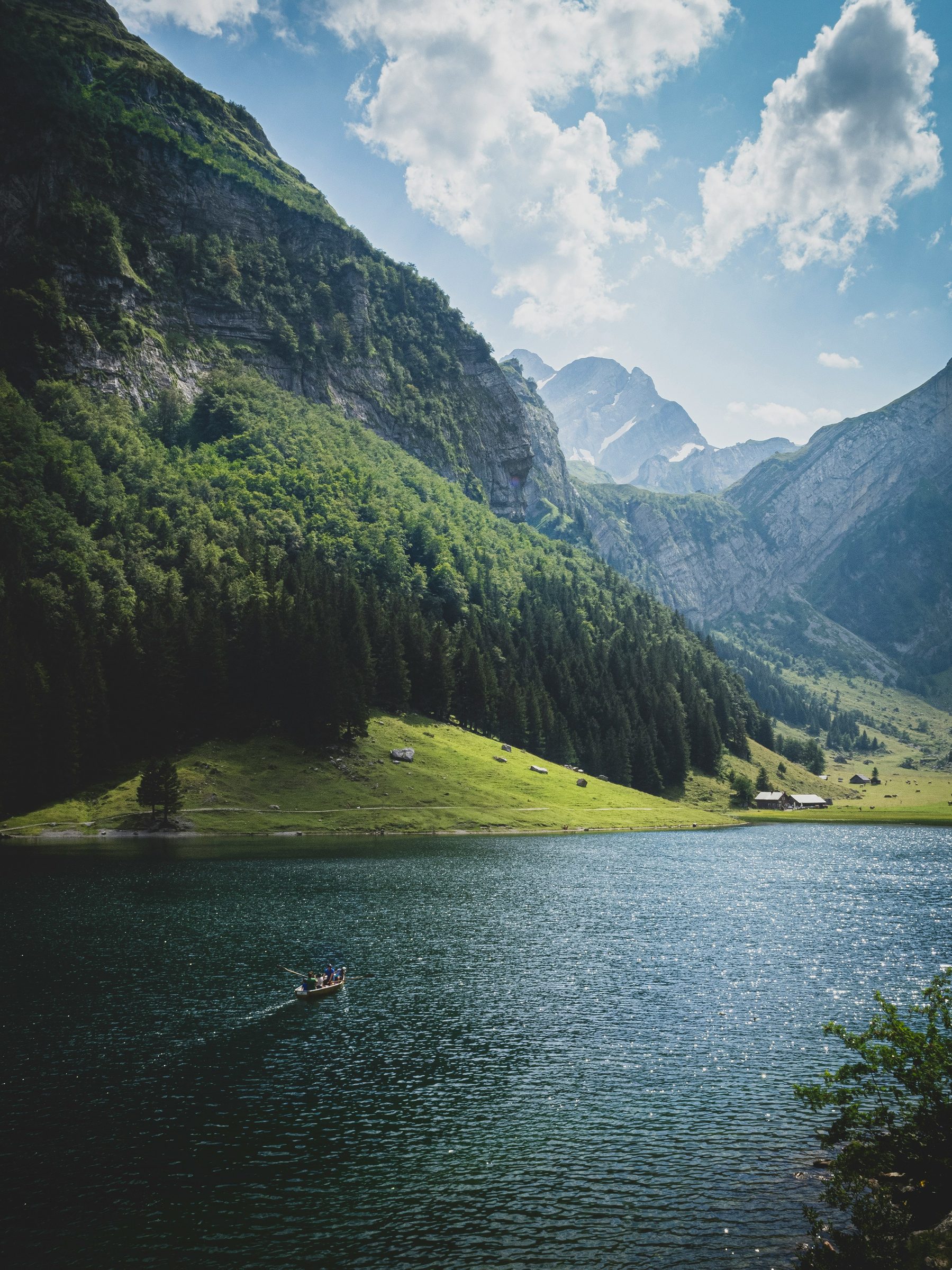 A small boat on a green alpine lake, Switzerland