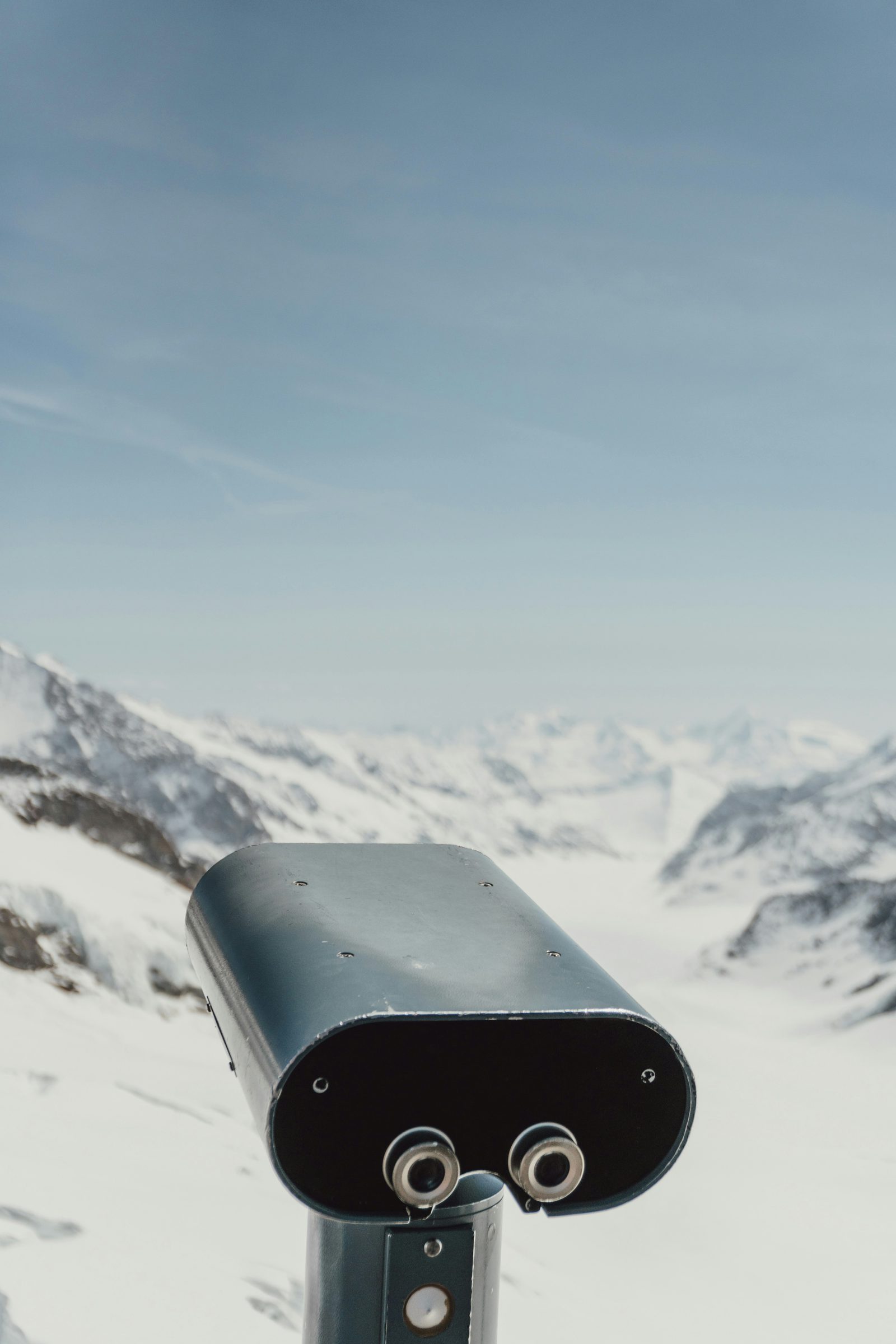 A summit telescope over the snowfields, St Moritz, Switzerland