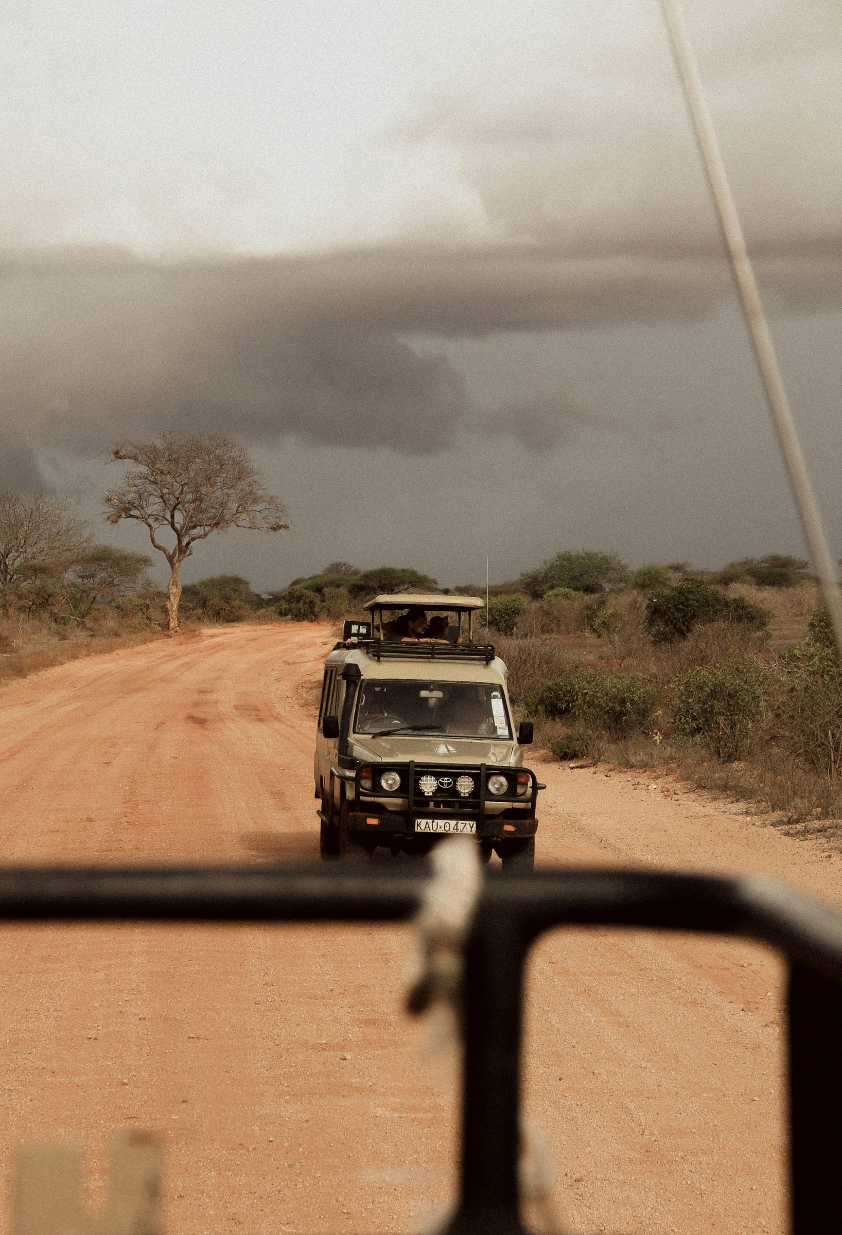 An open road leading toward a dramatic far horizon at dusk
